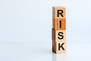 RISK cube wooden blocks on white table background. Home, Crisis, Economic recession, Buy concept. Free space on the left