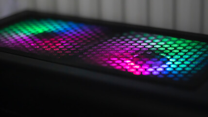 System unit, computer with RGB backlit light cooler. Neon multicolored light in the dark.