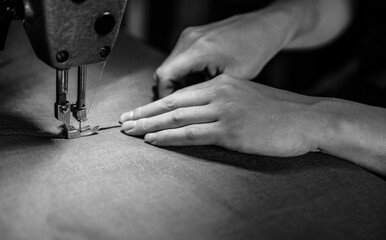 Hand near a sewing machine