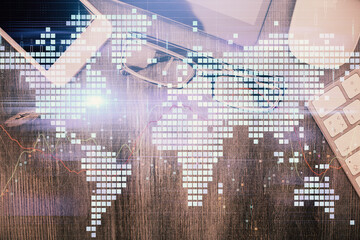 Double exposure of business theme hologram over desktop with phone. Top view. Mobile international trade connection concept.