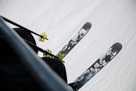 POV Skier In Skis Riding Ski Lift Above Snowy Ski Slope