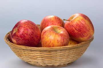 Basket with several apple selected. White background.