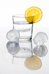 Glass of water with a lemon slice an ice cubes