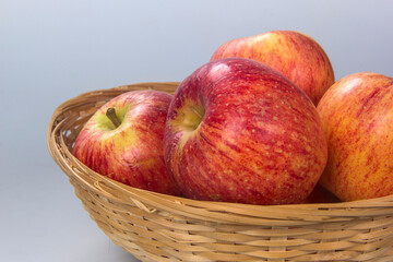 Basket with several apple selected. White background.
