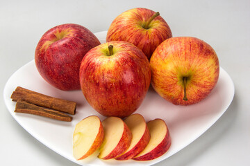 Apple. Slices of apple on the plate with cinnamon in pieces.