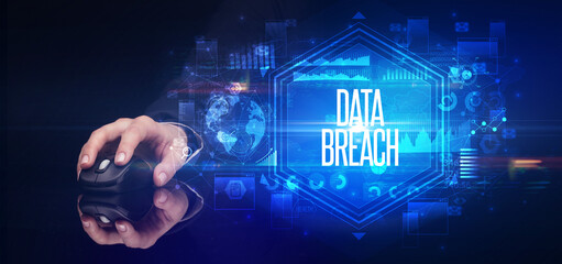 hand holding wireless peripheral with DATA BREACH inscription, cyber security concept
