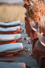 Wedding rustic decorations. Dry summer flowers. Covered festive table. Bride idea. Decoration table.