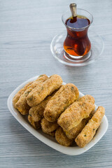 Crispy potato gratin and tea on wooden table.Vertical image.