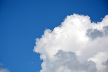 Obraz premium Edge of a beautiful white cloud on a blue sky, horizontal photo.