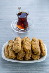 Crispy potato gratin and tea on wooden table.Vertical image.