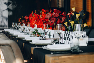 tableware Glasses, flower fork, knife served for dinner in restaurant with cozy interior
