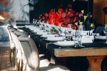 tableware Glasses, flower fork, knife served for dinner in restaurant with cozy interior