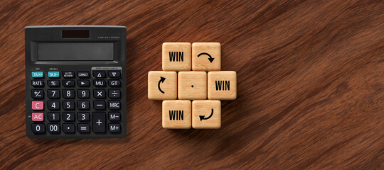 cubes with message WIN -> WIN -> WIN and a calculator on wooden background