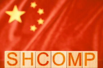 shcomp index china. wooden blocks with the inscription shcomp on the background of the flag of china
