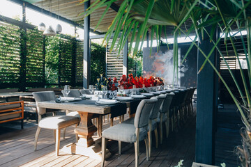tableware Glasses, flower fork, knife served for dinner in restaurant with cozy interior