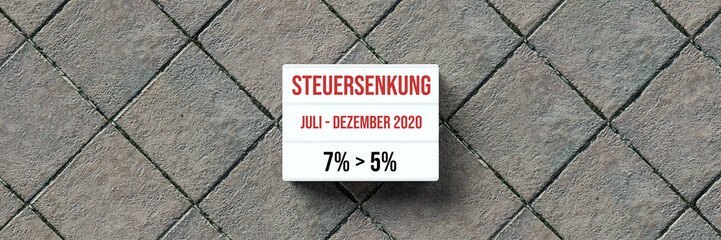information about the temporary German VAT reduction in 2020 from 7% to 5% on a lightbox in front of stone background