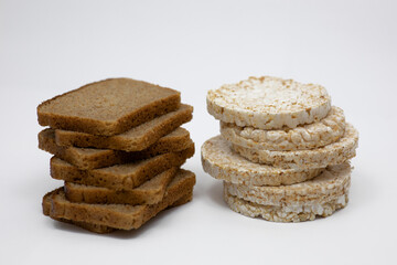 Wholemeal rye bread and rice wafers on a white background.