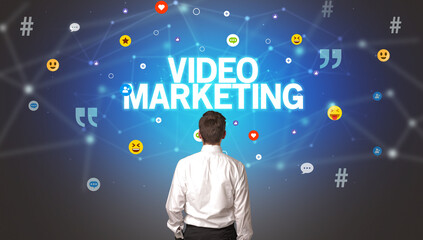 Rear view of a businessman with VIDEO MARKETING inscription, social networking concept