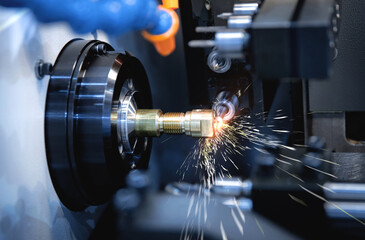 Metal machine tools industry. CNC turning machine high-speed cutting is operation.flying sparks of...