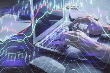 Double exposure of woman hands typing on computer and forex chart hologram drawing. Stock market invest concept.
