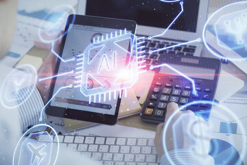 Double exposure of man's hand holding and using a digital device and data theme hologram drawing. Technology concept.