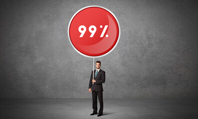 Obraz premium Young business person holdig traffic sign with 99% abbreviation, technology solution concept