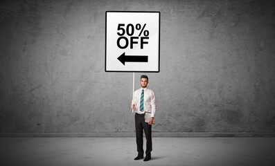 business person holding a traffic sign with 50% OFF inscription, new idea concept