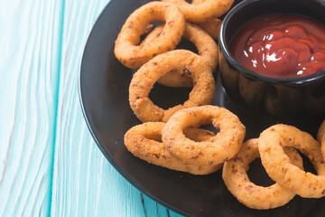 Crunchy fried onion rings and ketchup
