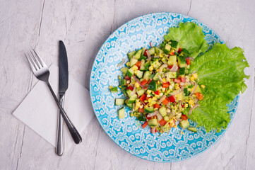 Hawaii style vegetarian raw eating salad.  served in beautiful blue plate on white table. flat lay