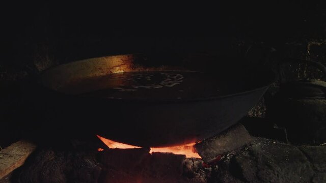 Coconut sugar being cooking in wok over fire stove