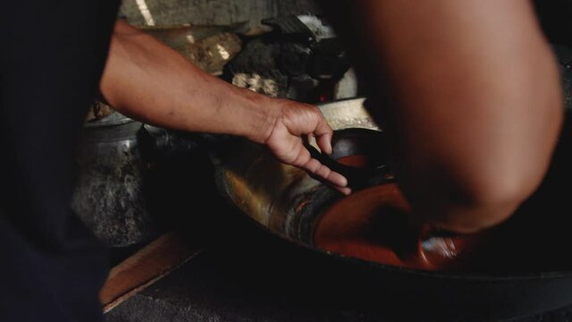 Pouring Coconut sugar made from coconut nectar into coconut shells