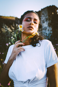 A fashionable moroccan beauty in a spring outdoors session in a flowers background
