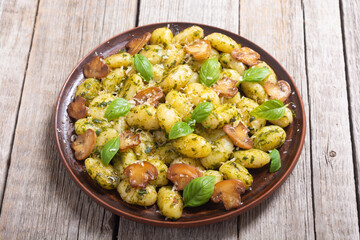 Homemade potatoes gnocchi with basil , cheese and mushrooms