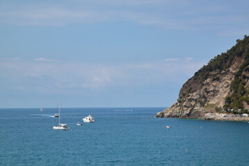 Fototapeta na wymiar Five Lands, Italy - Pleasure tourist boats stop off the coast of Moneglia