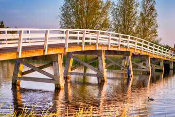 Fototapeta premium Traditonal Wooden Dutch Bridge in Kinderdijk Village in the Netherlands.
