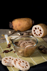 Lotus root soup with beans in a bowl and Chinese herbs, shiitake mushroom, lotus root