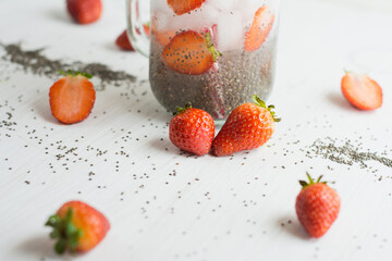 chia seeds and strawberry water, white background.