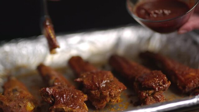 Silicone basting pastry brush spreading marinade for BBQ Grill ribs in 4K.