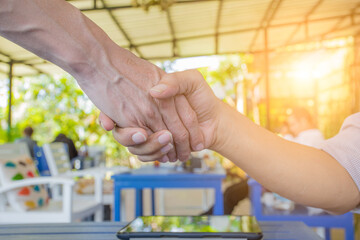 Business shaking hands after making agreement in office