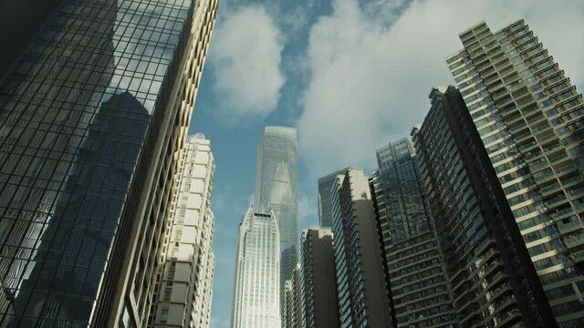 Clouds reflection in Guangzhou downtown office buildings and skyscrapers in early morning. China.