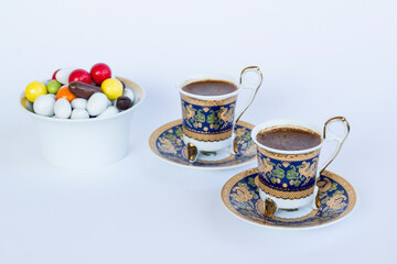 Traditional Turkish Colorful Almond Candies and coffee on white with copy space.
