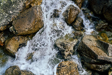 Naklejka na ściany i meble Mountain fresh, cold stream with drinking clean water in High Tatras National Park, Slovakia, Europe. Beautiful world.