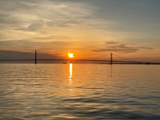 Fototapeta na wymiar bridge sunset over the sea