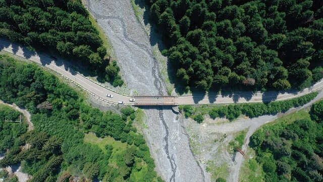 Cars Crossing On The Bridge In Shovi, Region Of Racha In Georgia On A Sunny Day - top-down aerial shot