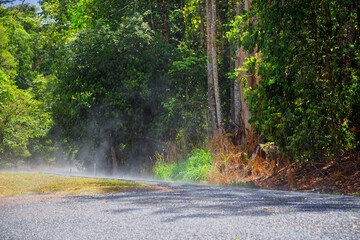 Steam rising from hot road on the Atherton Tableland in Tropical North Queensland, Australia