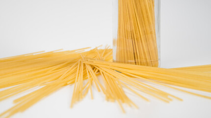 Raw spaghetti on white background.