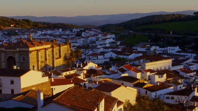 zoom out from the small rural houses of the town of Jabugo, white with their orange roofs. during dawn, with the first rays of the sun showing us the peaceful and unique rural town