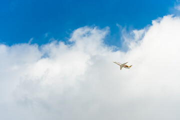 Airplane climbing above clouds