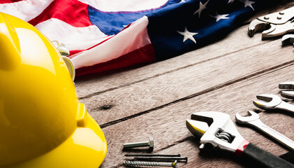 USA Labor day concept, Top view flat lay of different kinds wrenches with American flag on wood table. First Monday in September, creation of labor movement and dedicated to social of American worker