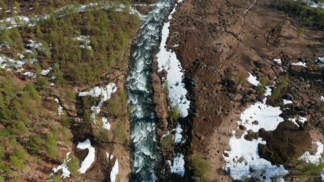 Aerial view rapids high up in the Lyngen alps , sunny summer day, in  North Norway - Top down, drone shot